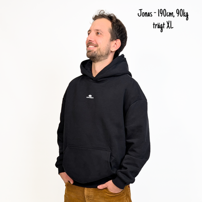 Jonas (190cm, 90kg) trägt den sandfarbenen Klub Streets Hoodie in XL. Man sieht das Model von vorne. Der Hoodie hat einen kleinen Print auf der Brust: ein quer liegender Rugby Ball, darunter der Schriftzug Klub Klamotte.